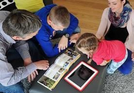 A family is looking at a catalogue